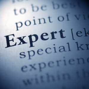 Photo of the word "expert" in a dictionary with definition excerpt.